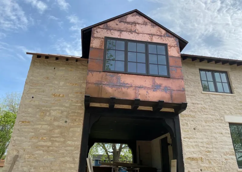 Copper metal panel facade on a stone building for Skylight Installation in Wade Hampton
